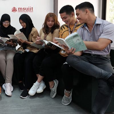 Students talking while reading books.